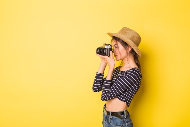 Woman photographer beauty caucasian brunette young girl on yellow background