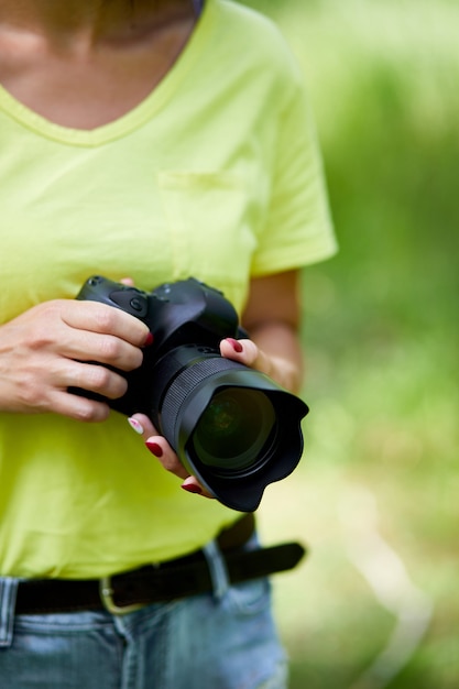 Woman photographer with a photo camera in hand outdoor, World photographer day, creative hobby, copy space, place for text, Photography Concepts Professional.