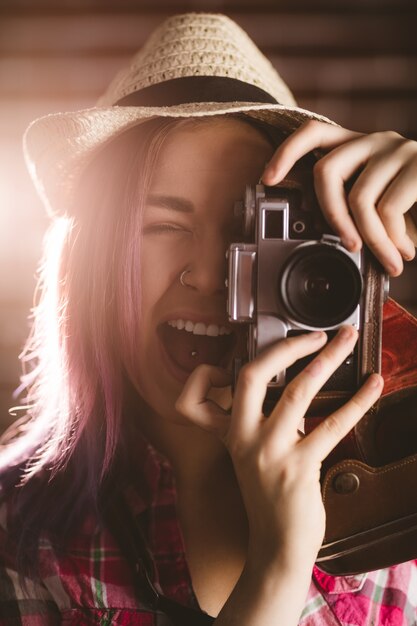 Woman photographing from vintage camera