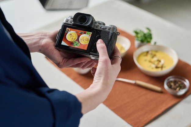 Woman photographing lunch with camera