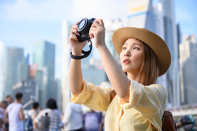 Photo woman photographing with camera in city