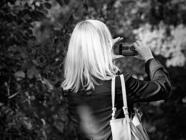 Woman photographing with phone