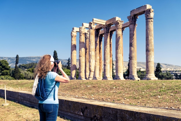 Woman photographs the Temple of Olympian Zeus Athens