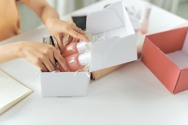 Woman picking beauty box package and collect the cosmetics product