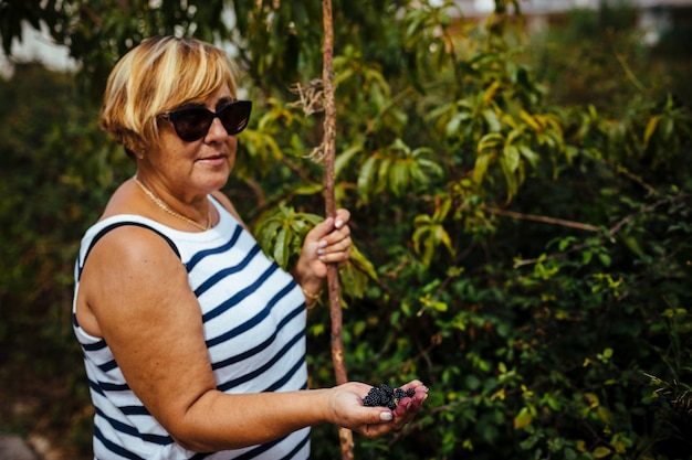 Woman picking wild blackberries