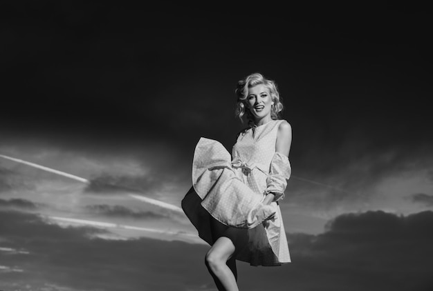 woman in pink dress on sunset monroe style beautiful girl in stylish fashion clothes in summer fashi