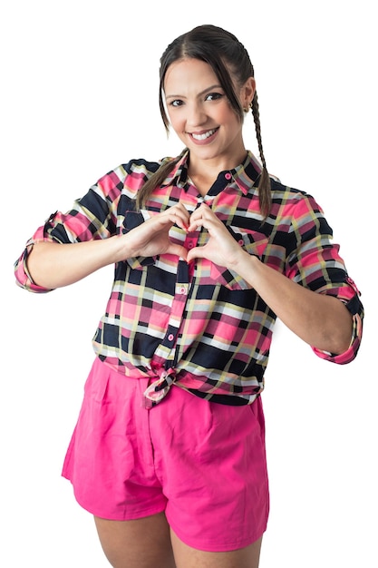 A woman in a pink shirt is making a heart with her hands.