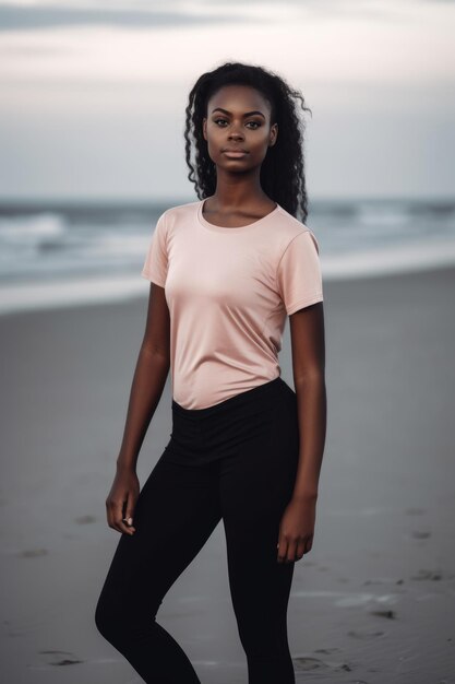 A woman in a pink shirt stands on the beach