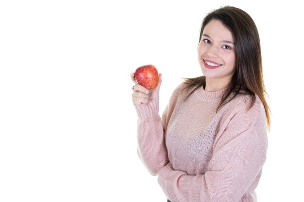 Woman in pink sweater hold green apple