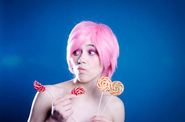 Woman in pink wig eating candies