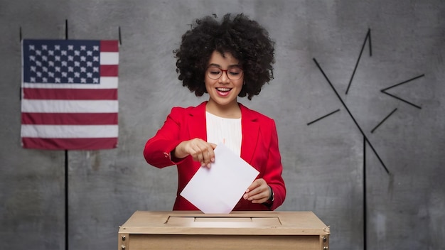 Photo woman placing ballot in box