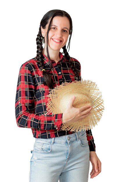 A woman in a plaid shirt and a hat is holding a straw hat.