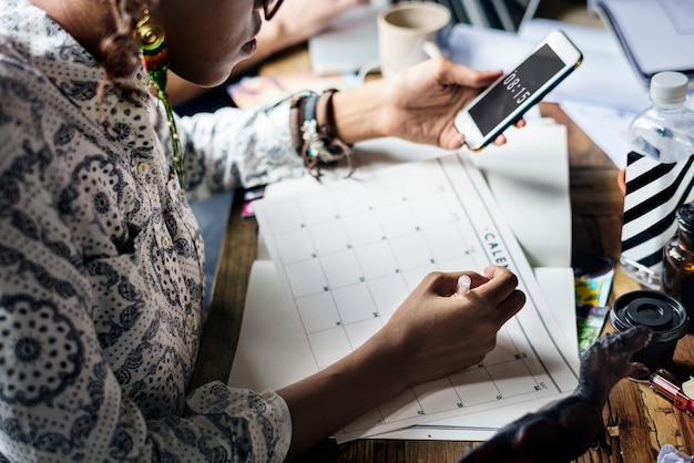 Woman Planning Writing Note on Calendar