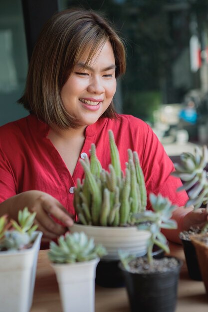 小さな家の庭で多肉植物を植える女性