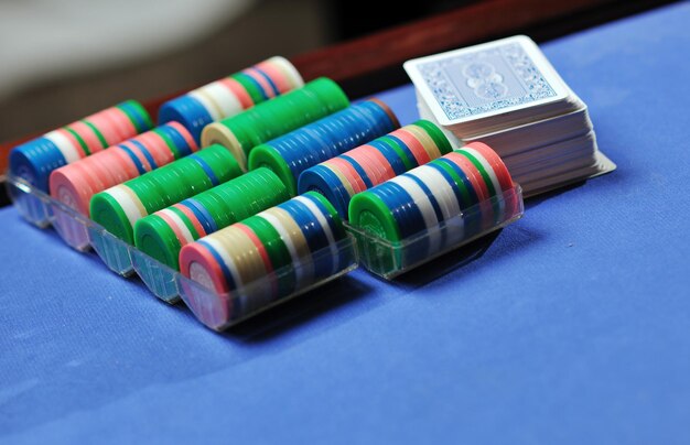 woman play black jack card game in casino on blue table