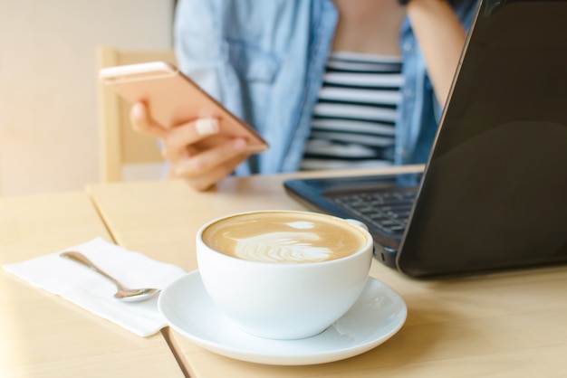 Woman play smartphone in coffee shop