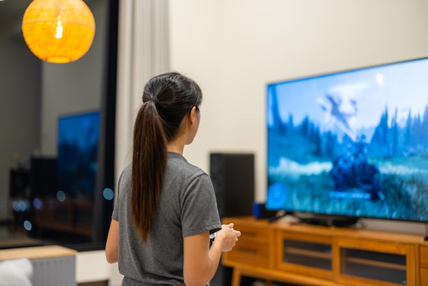 Woman play the video game at home