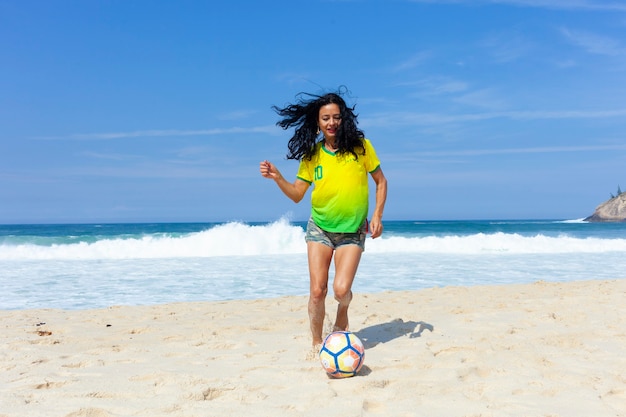 Woman playing ball on the beach, Rio de Janeiro.