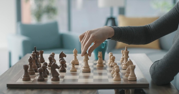 Woman playing chess at home