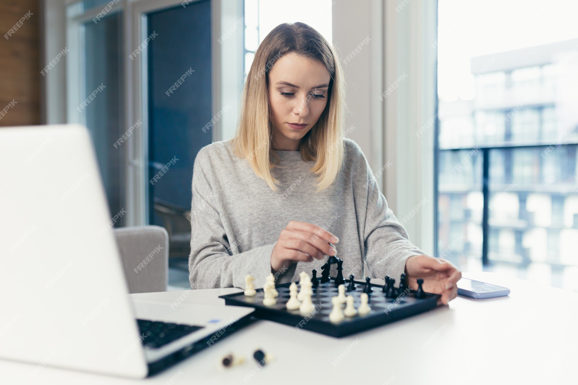 Premium Photo  Girl playing chess online on tablet computer