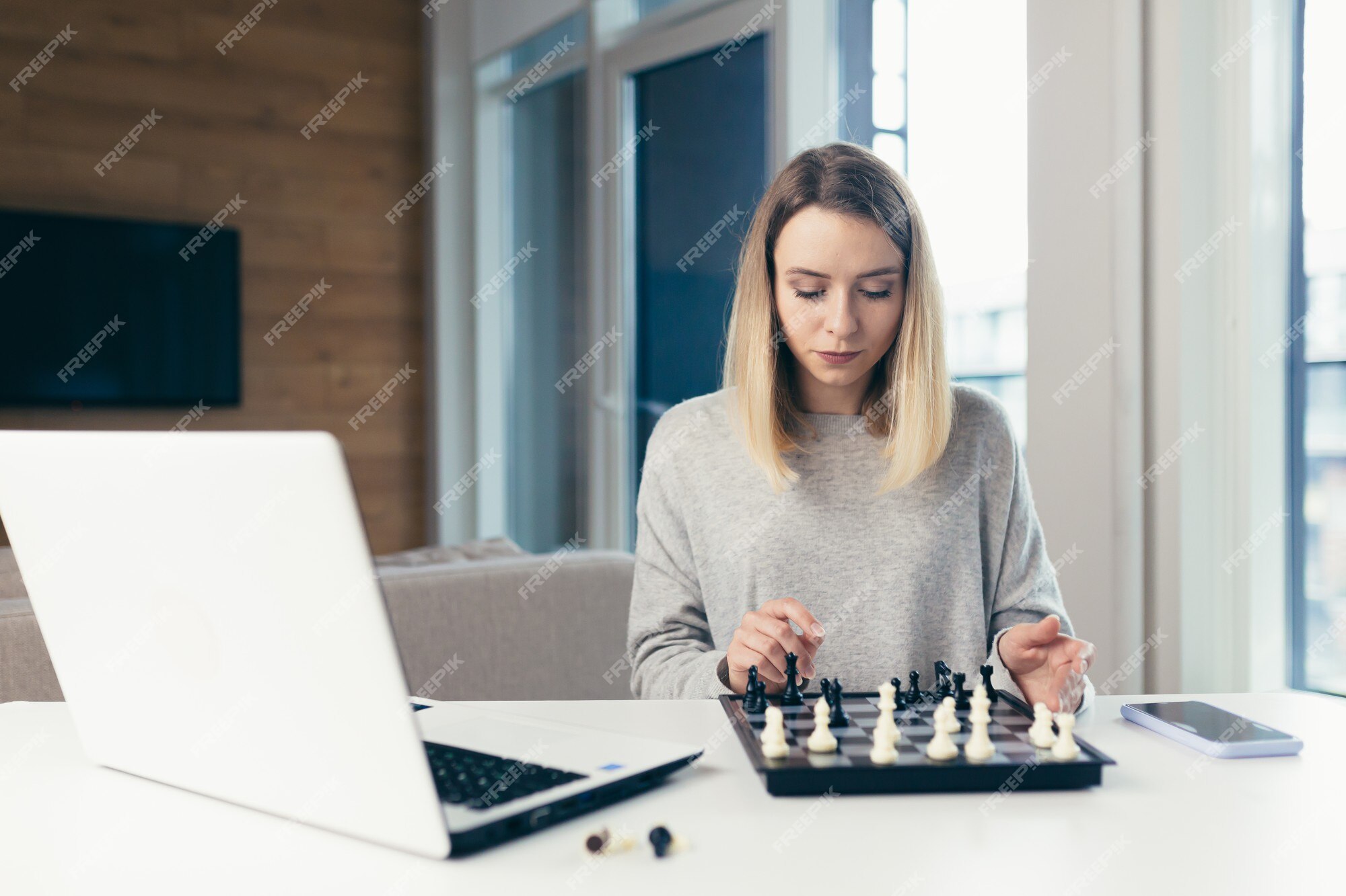 Premium Photo  Girl playing chess online on tablet computer