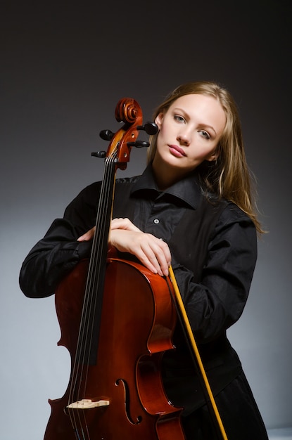 Woman playing classical cello in music concept