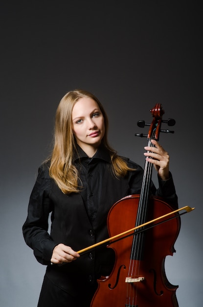 Woman playing classical cello in music concept