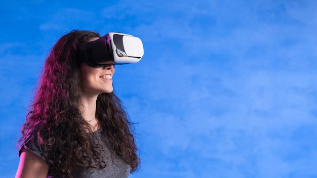 Woman playing games on vr set copy space