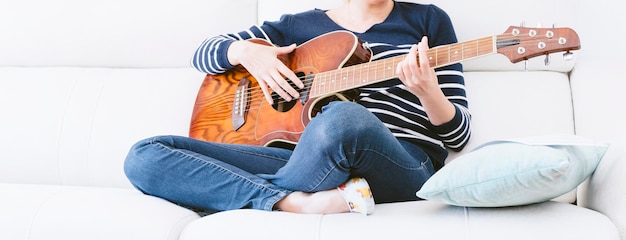 Woman playing guitar in a relaxed way Selective focus