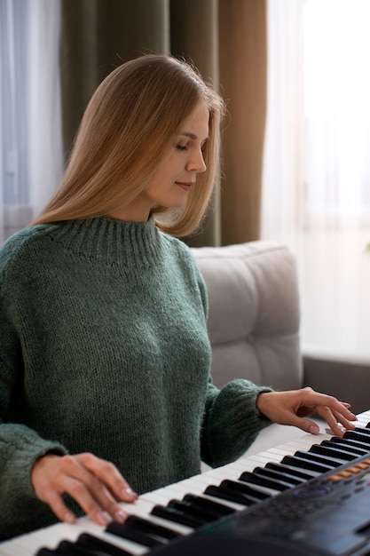 Woman playing piano medium shot