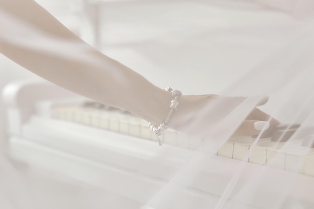 A woman playing the piano a woman\'s hand closeup