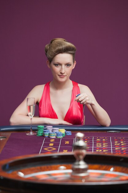 Woman playing roulette with champagne