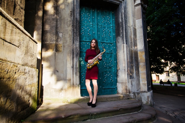 Woman playing saxophone in the city streets