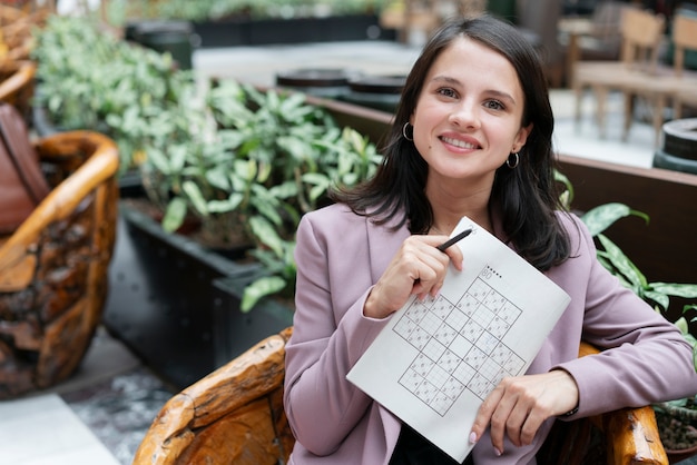 Foto donna che gioca da sola a un gioco di sudoku