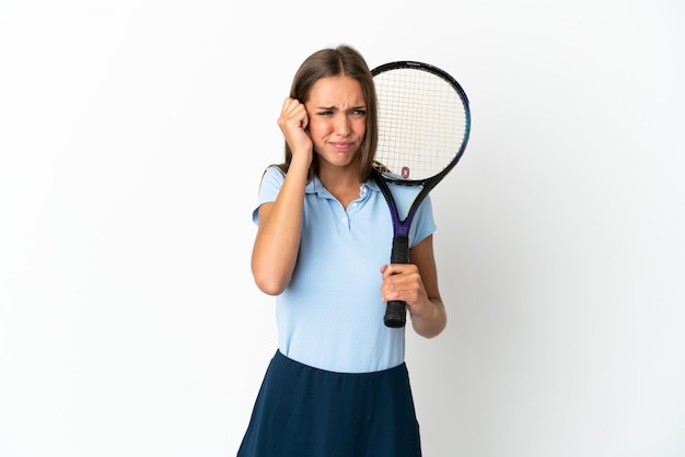 Woman playing tennis over isolated white wall frustrated and covering ears