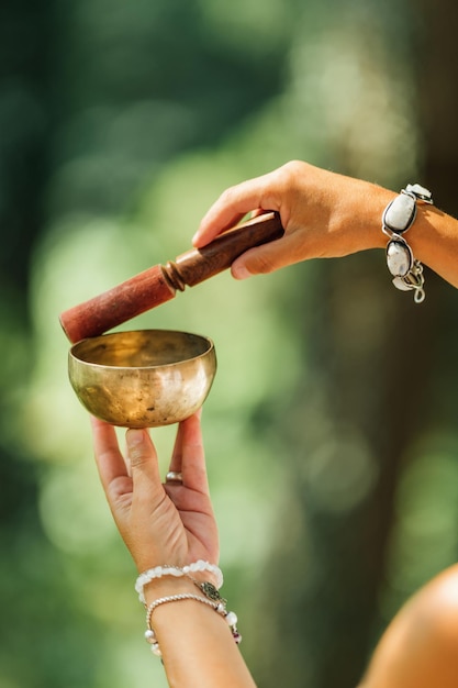 Woman Playing on Tibetan Singing Bowl