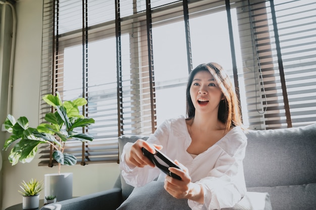 woman playing video game at home in living room