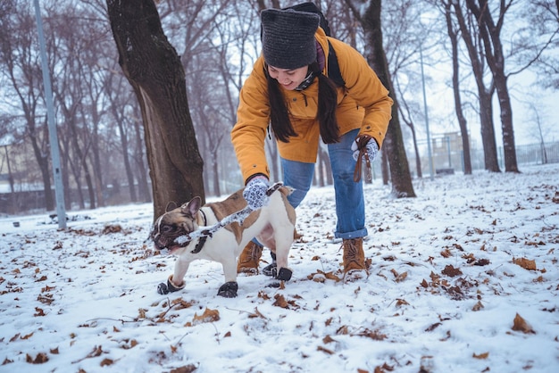 Woman playing with french bulldog