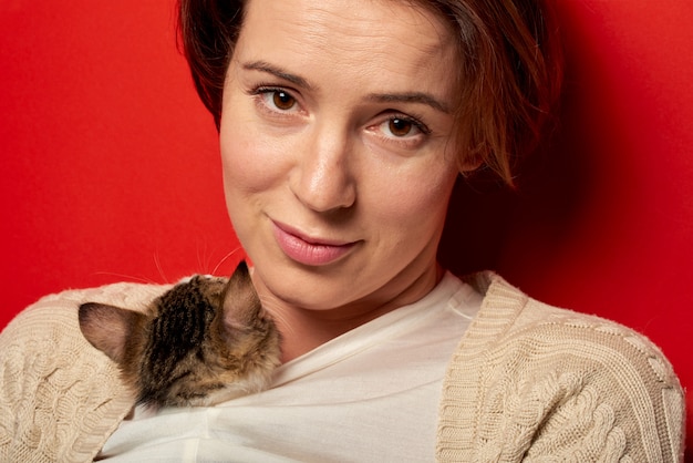 Woman playing with a little cat