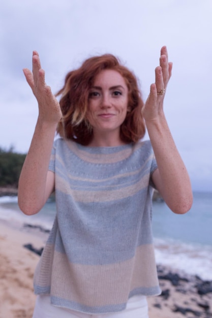 Woman playing with sand at beach