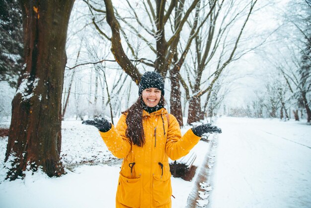 Woman playing with snow in snowed city park