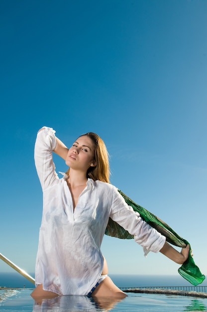 Woman playing with water under the sun