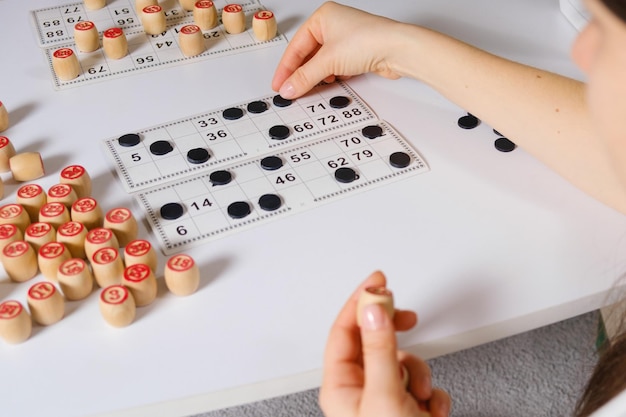 A woman plays a table game of Russian lotto