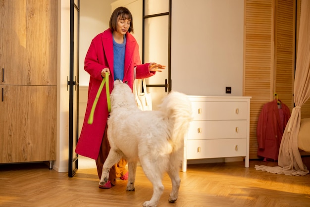 Woman plays with her dog before going out for a walk