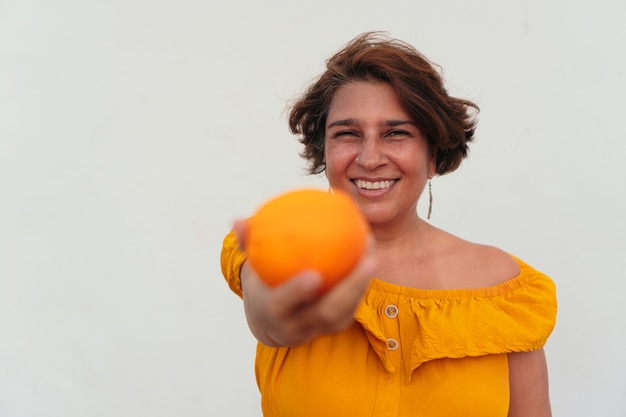 Woman plays with oranges in the open air