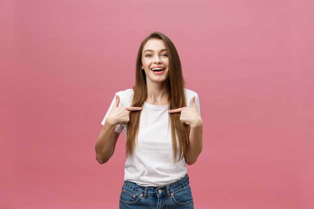 Woman pointing finger at camera and toothy smiling