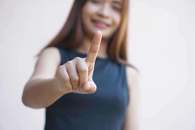 Woman pointing finger forward to press button