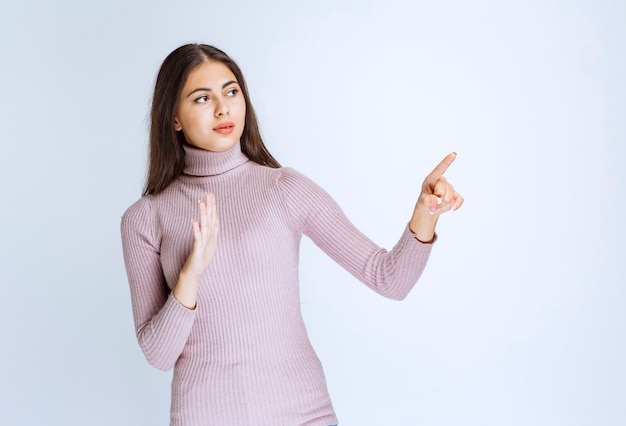 woman pointing at something and stopping it.