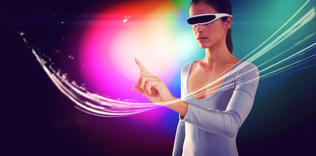 Woman pointing while using virtual video glasses