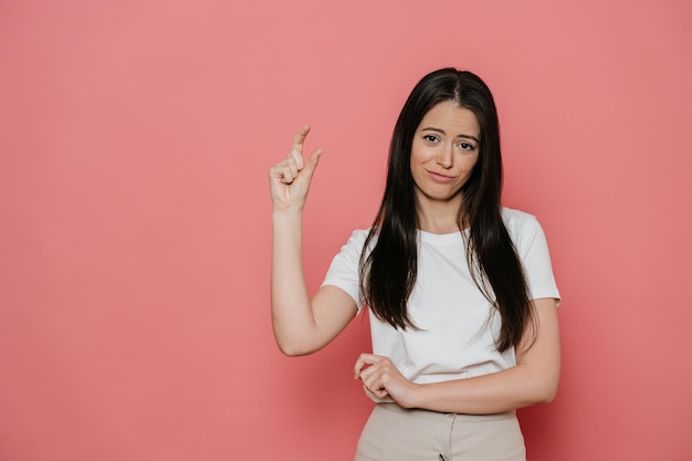 A woman points her finger at the camera.